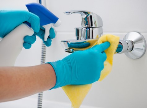 Local cleaner treating stains on a living room sofa in Greenwich